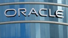 A photo of the Oracle logo on the side of a glass office building.