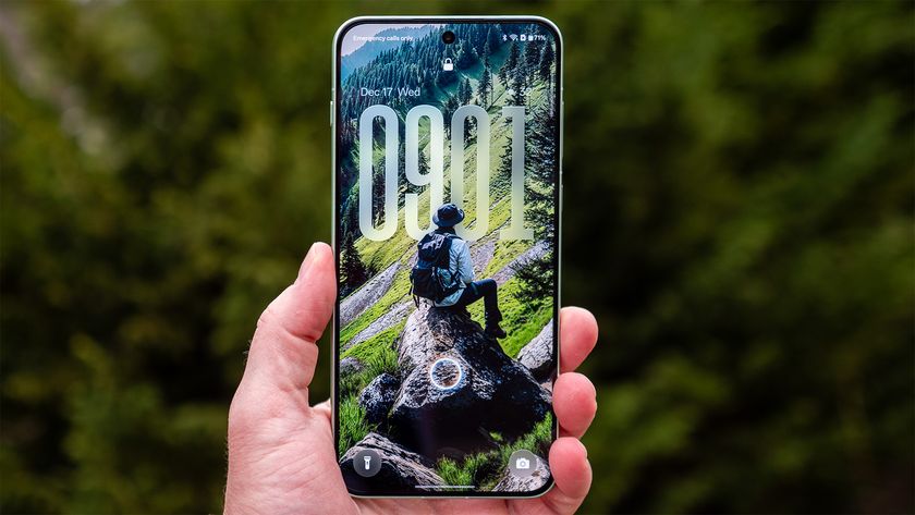 A OnePlus 15R with a Flux Themes forest wallpaper on the lockscreen