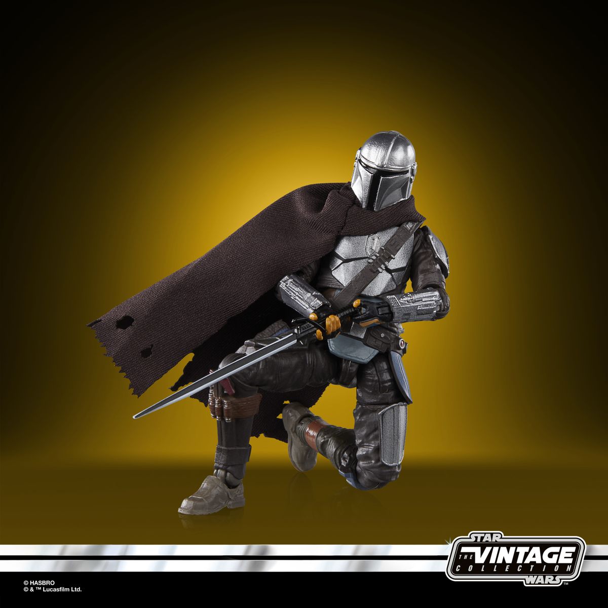 The Vintage Collection Mandalorian figure, posed on a yellow and black background