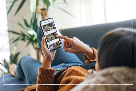 Woman lying on sofa and ordering food on takeaway delivery app