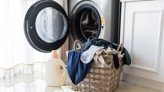 Basket with laundry and washing machine