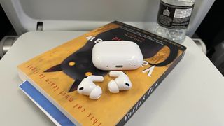 Apple AirPods Pro 2 positioned on a book