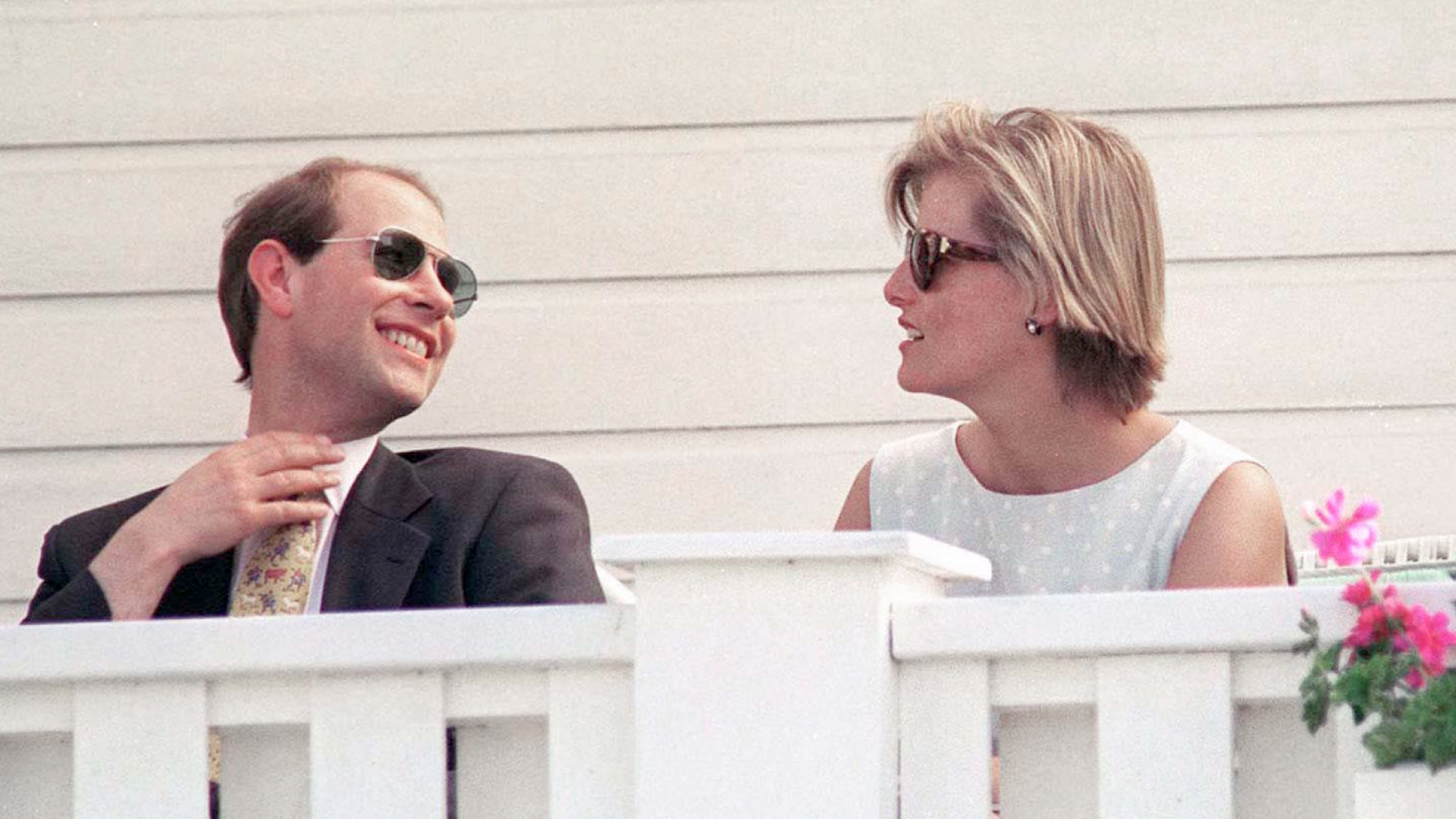Prince Edward and Sophie Rhys-Jones sitting in front of a white railing