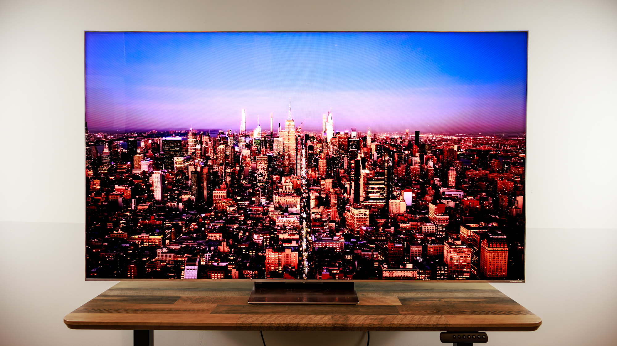 A 75-inch TCL QM8L TV on a desk