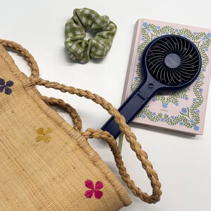 John Lewis fan on a note book next to a bag