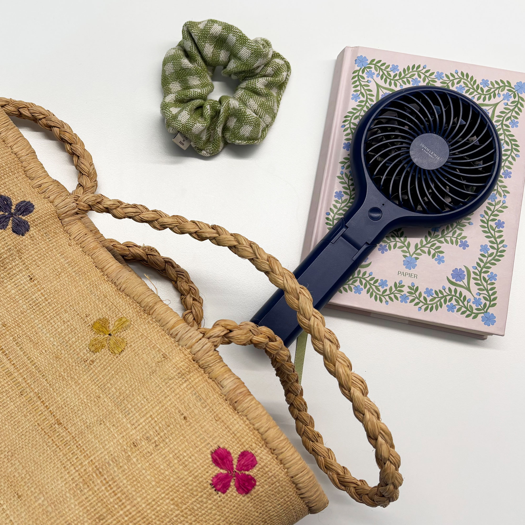 John Lewis fan on a note book next to a bag