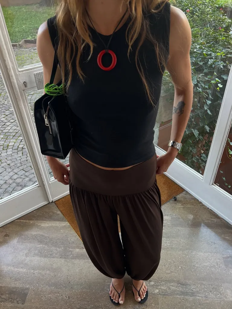 Woman in a black top and balloon pants