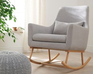 Tutti Bambini Oscar Rocking Chair in a minimalist modern nursery with a grey footstool, window and plants to the left