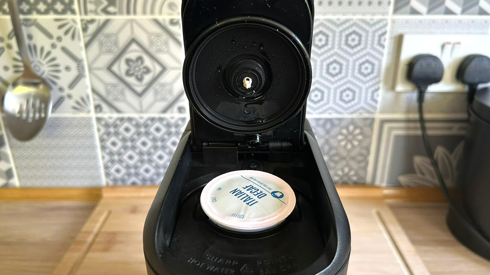 Keurig K-Mini Mate coffee maker on kitchen counter with K-Cup inserted