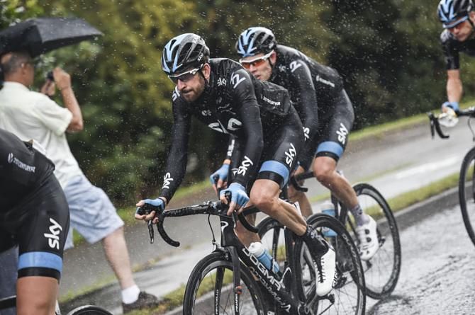 Team Sky's Bradley Wiggins rides through the rain in London