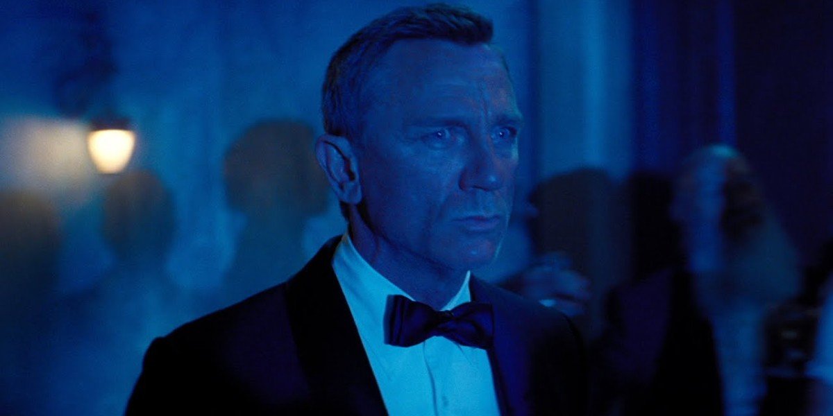 No Time To Die Daniel Craig worried and tuxedoed in blue light