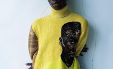 Yellow roll neck jumper with black face on by Dior