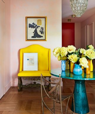 colorful entrance hall with yellow bench and art deco chandelier