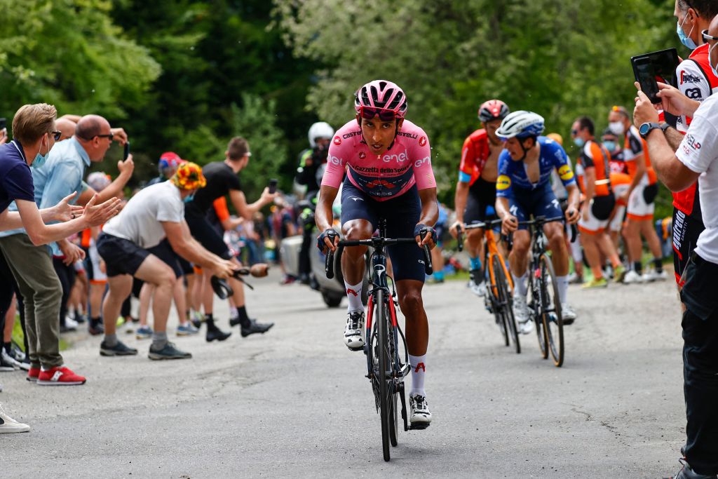 Overall leader Team Ineos rider Colombias Egan Bernal rides in the final ascent followed by Team Deceuninck rider Portugals Joao Almeida and Team Bahrain rider Italys Damiano Caruso during the 19th stage of the Giro dItalia 2021 cycling race 166km between Abbiategrasso and Alpe di Mera on May 28 2021 Photo by Luca Bettini POOL AFP Photo by LUCA BETTINIPOOLAFP via Getty Images