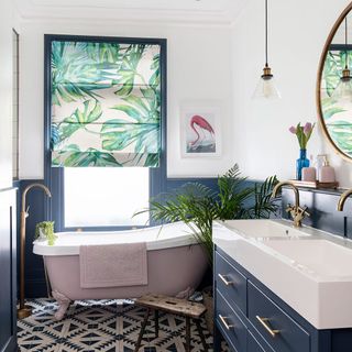 Blue bathroom with white bath and copper taps