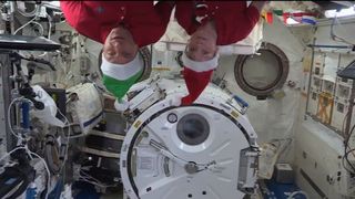 Happy holidays from space! NASA astronaut Anne McClain (right) and David Saint-Jacques of the Canadian Space Agency search for the Elf on the Shelf aboard the International Space Station in a Christmas 2018 video.