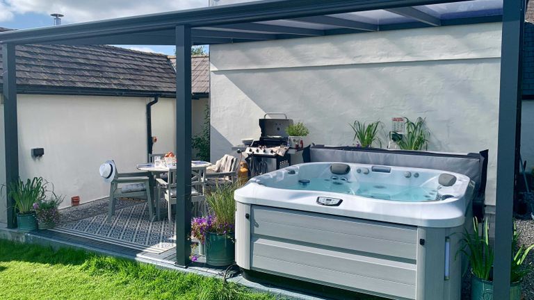 hot tub shelter ideas: pergola and seating space over hot tub from Hydrolife