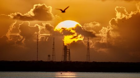a sunrise over the space launch system artemis 2 rocket