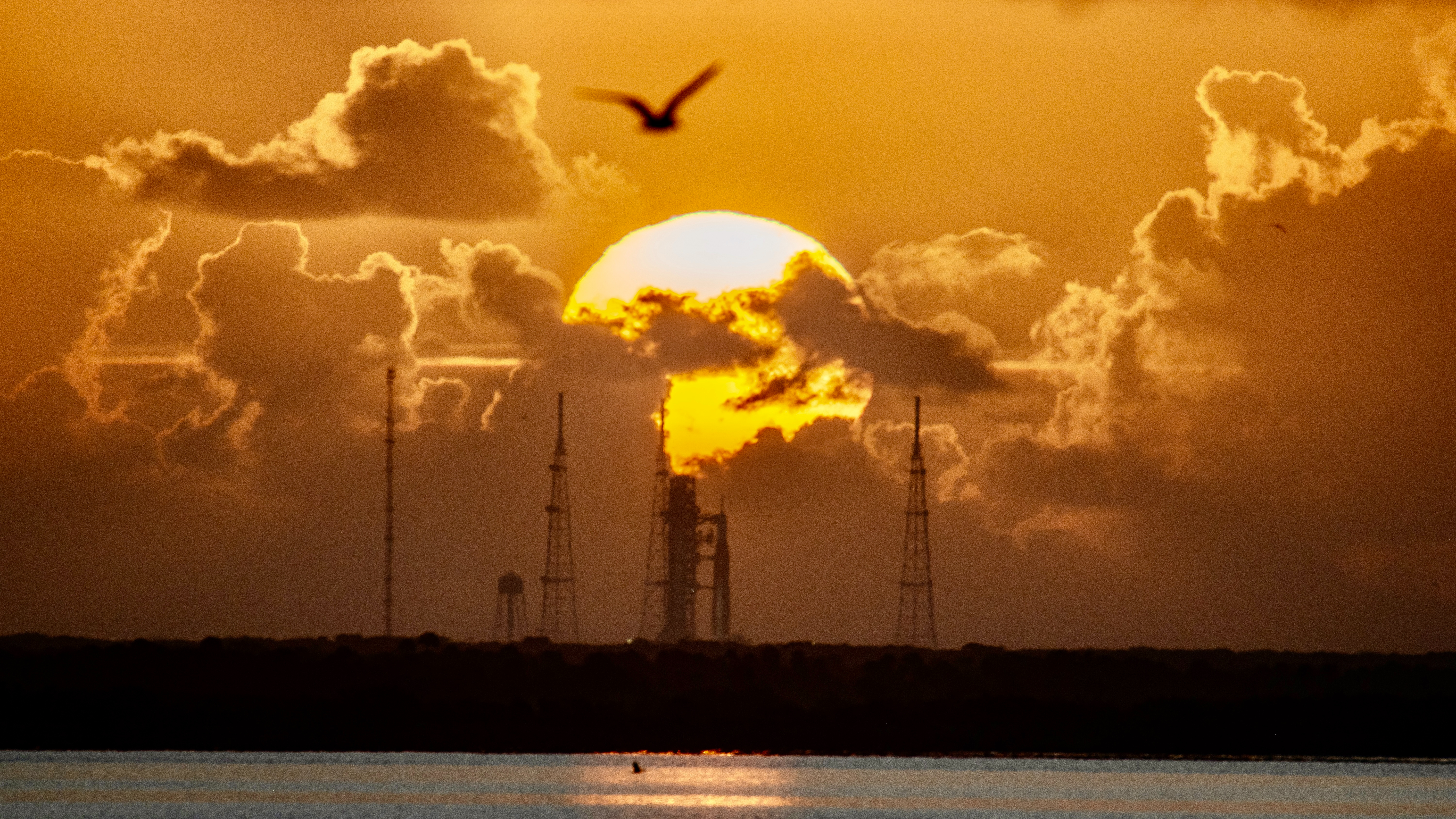 a sunrise over the space launch system artemis 2 rocket