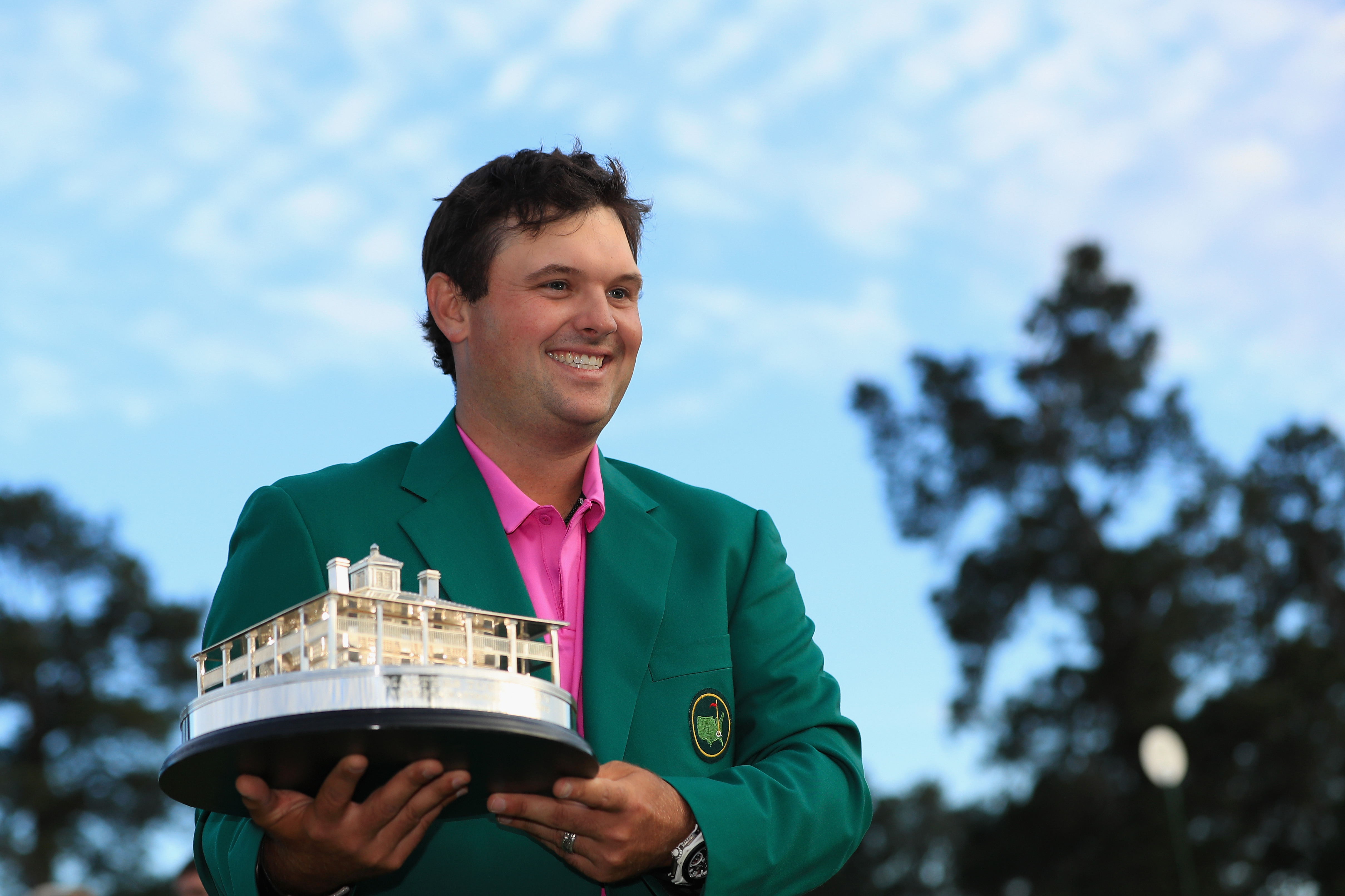 Patrick Reed holds The Masters trophy and celebrates