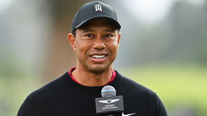 Tiger Woods speaks into a microphone