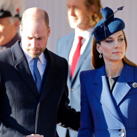 Prince William putting his hand on Princess Kate's back