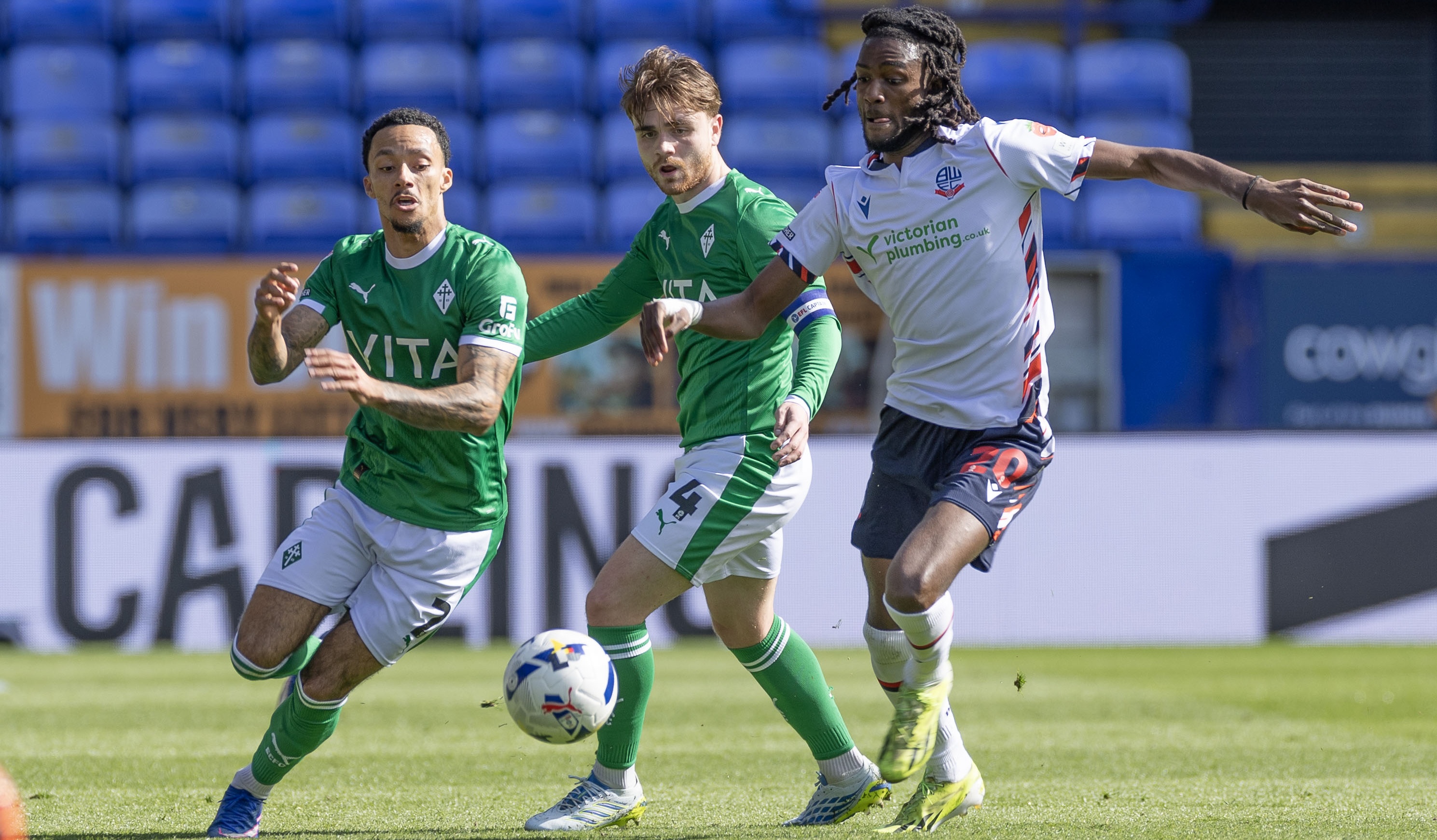 Josh Dacres-Cogley of Stockport County F.C. and Ibrahim Cissoko of Bolton Wanderers F.C. in action during the Sky Bet League One match between Bolton Wanderers and Stockport County 