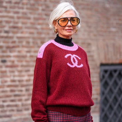 Best concealer for mature skin - Grece Ghanem wears sunglasses, golden earrings, a black turtleneck pullover , a pink and red Chanel pullover getty 1976105865