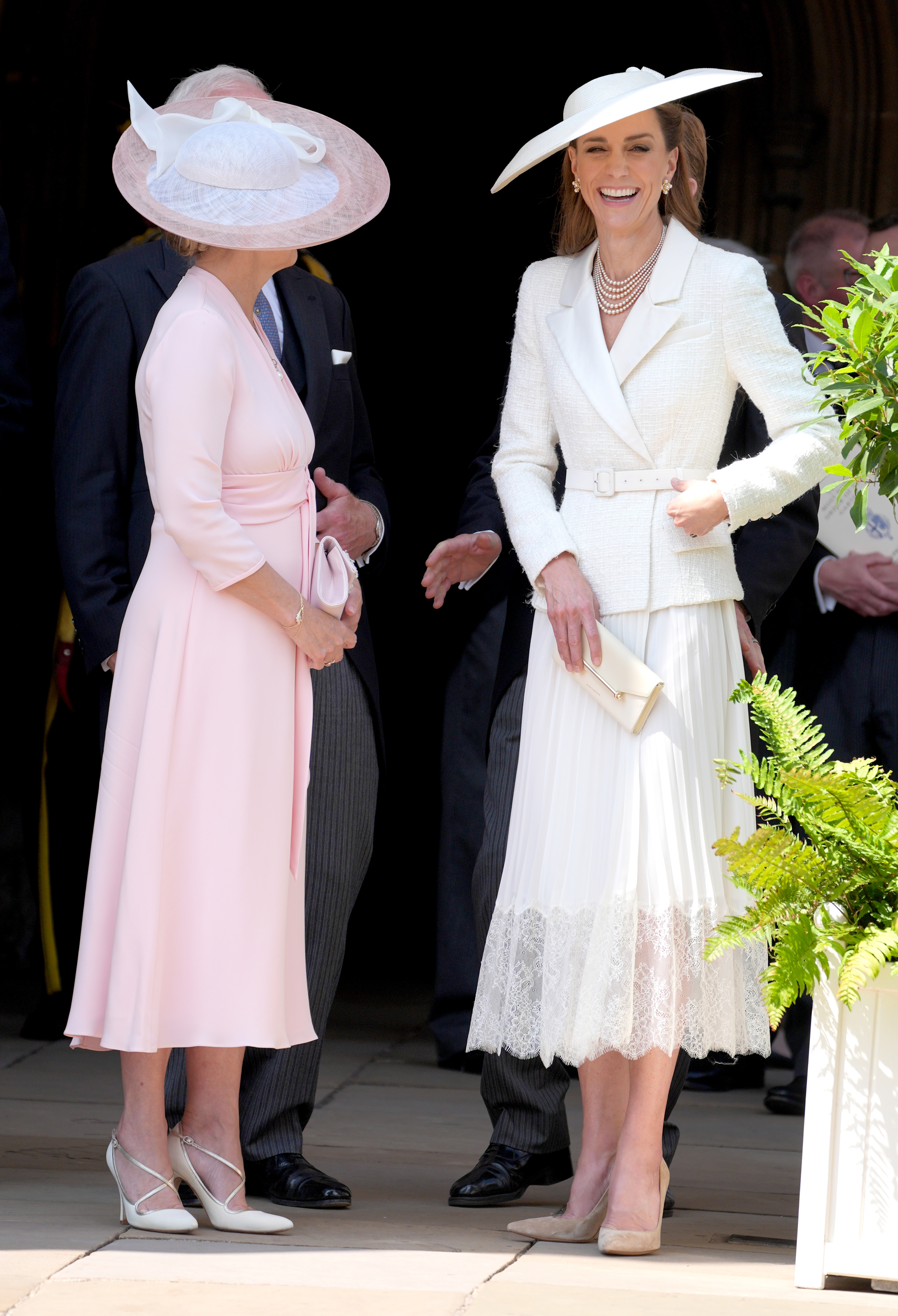 Princess Kate wearing a white blazer dress and laughing