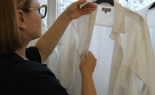 Woman inspecting a white shirt