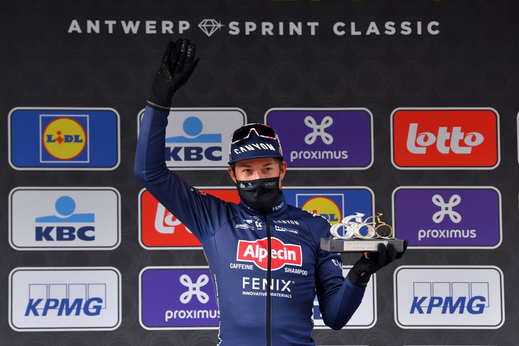 SCHOTEN BELGIUM APRIL 07 Podium Jasper Philipsen of Belgium and Team AlpecinFenix Celebration during the 109th Scheldeprijs 2021 Mens Elite a 1942km race from Terneuzen to Schoten Trophy Mask Covid Safety Measures Trophy SP21 FlandersClassic on April 07 2021 in Schoten Belgium Photo by Luc ClaessenGetty Images