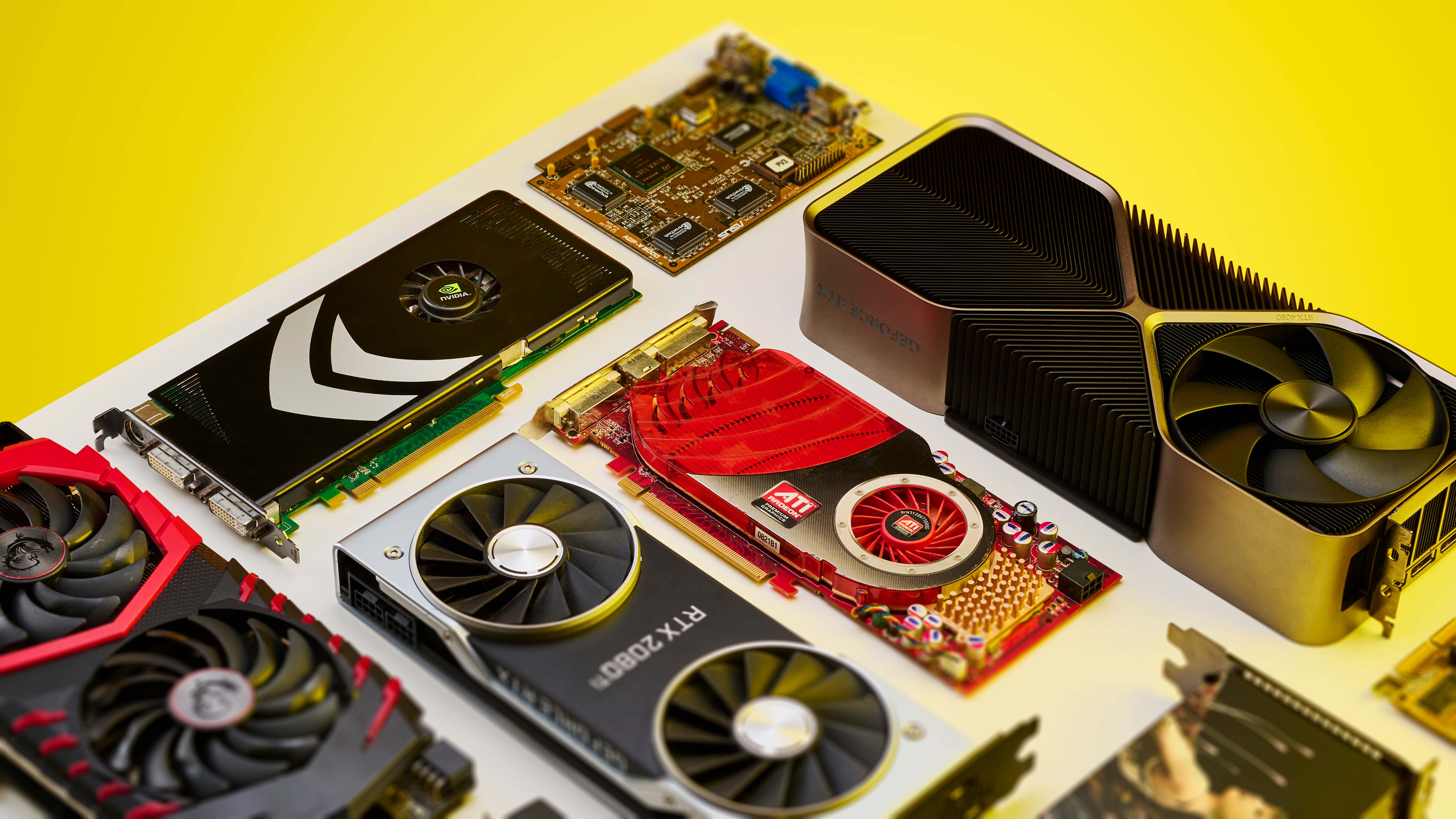 Different generations of graphics card all arrayed on a plinth with a yellow background.