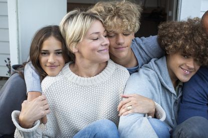 Parenting tips: smiling mother with daughter and sons siting together