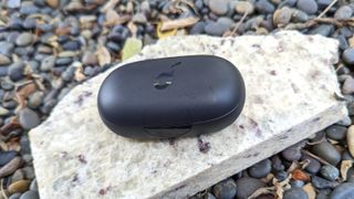 The Anker Soundcore Sport X10 charging case sitting on a marble surface