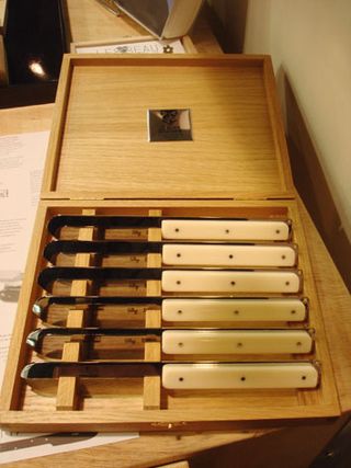 Knife set by French manufacturer Claude Dozorme. Knives with white handles in a wooden case.
