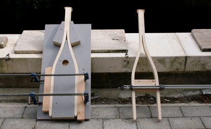 Seen during its manufacture, ‘One Step Ladder’ by Cameron Rowley. The wooden frame of the ladder held in a mould.