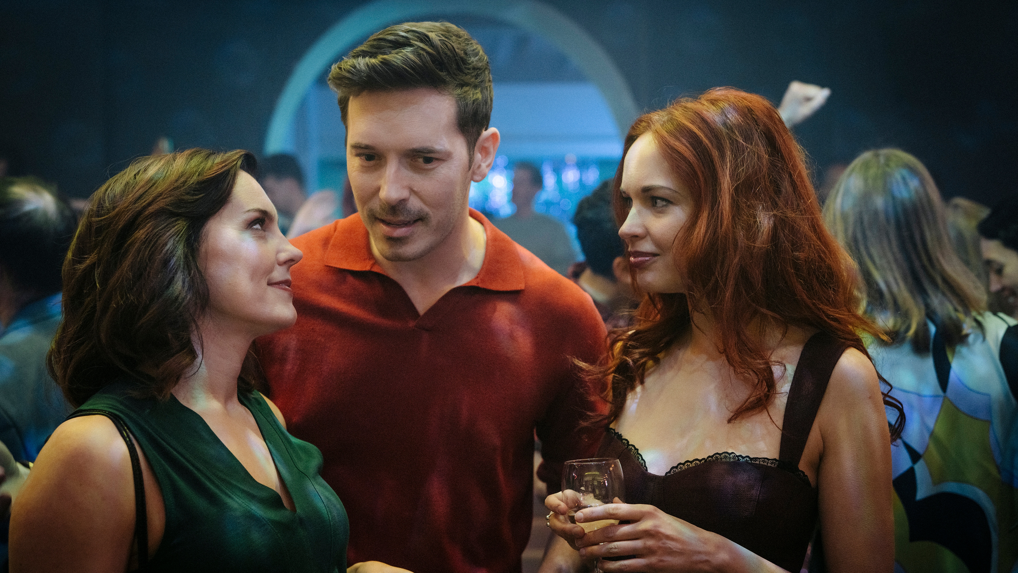 Annabel Scholey as Charlotte, Sam Palladio as Jacob and Aggy K Adams as Mia stand together in a night club in The Couple Next Door Season 2