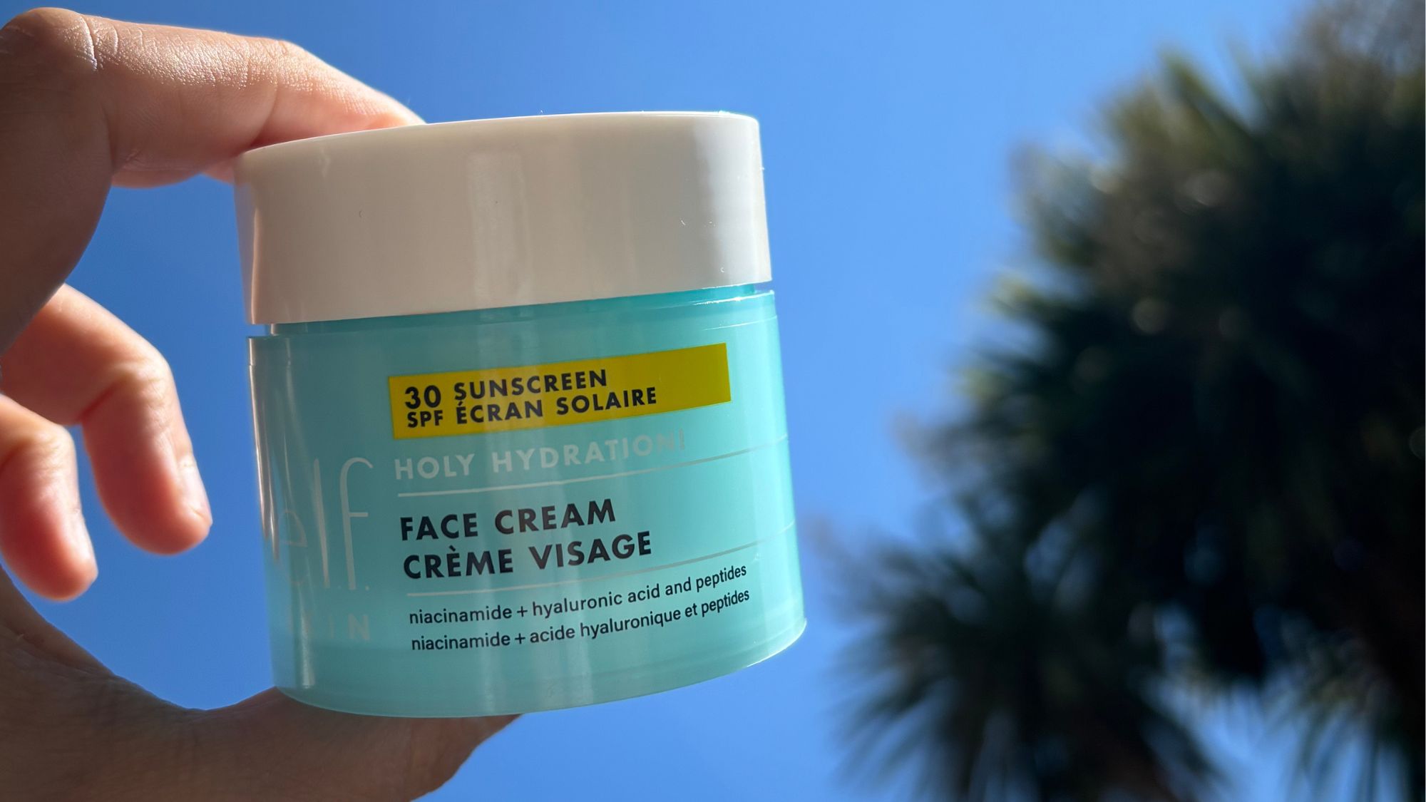 Mica Ricketts holding E.L.F. Skin Holy Hydration! Face Cream SPF 30