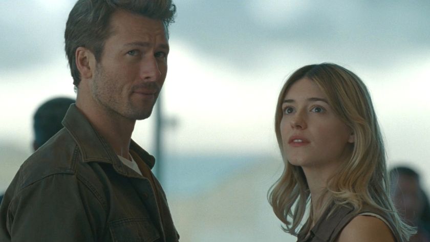 Glen Powell and Daisy Edgar-Jones look up together in anticipation in Twisters.