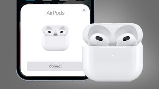 The Apple AirPods 3 next to an iPhone on a grey background