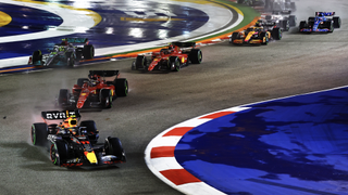 Max Verstappen leads the pack through an S bend under lights ahead of the 2023 Singapore Grand Prix. 
