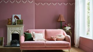 pink living room with pink sofa and fireplace