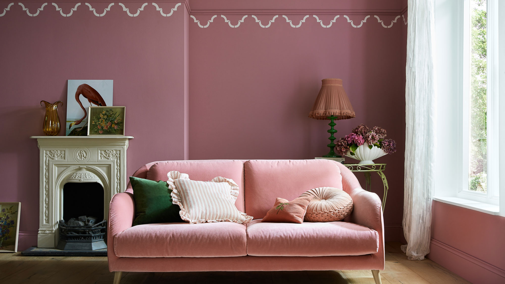 pink living room with pink sofa and fireplace