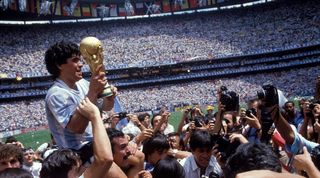 Diego Maradona lifts the World Cup trophy at Mexico's Estadio Azteca after Argentina's victory over West Germany in 1986.