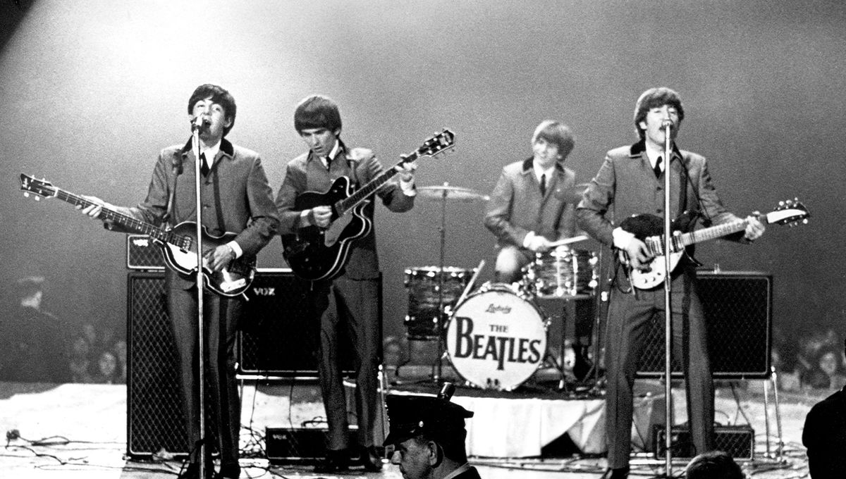 The Beatles perform onstage at the Washington Coliseum on February 11, 1964 in Washington, D.C.