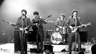 The Beatles perform onstage at the Washington Coliseum on February 11, 1964 in Washington, D.C.