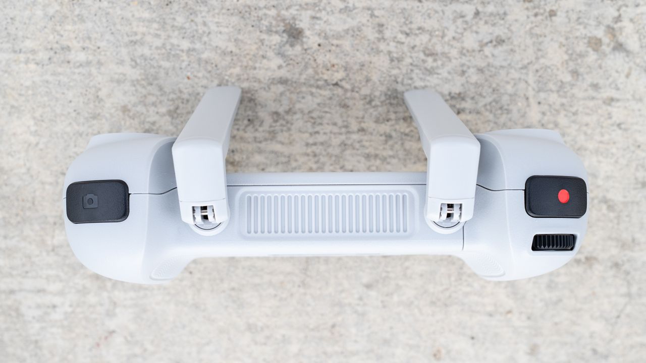 the side view of a white drone controller with two right-angled antennas.