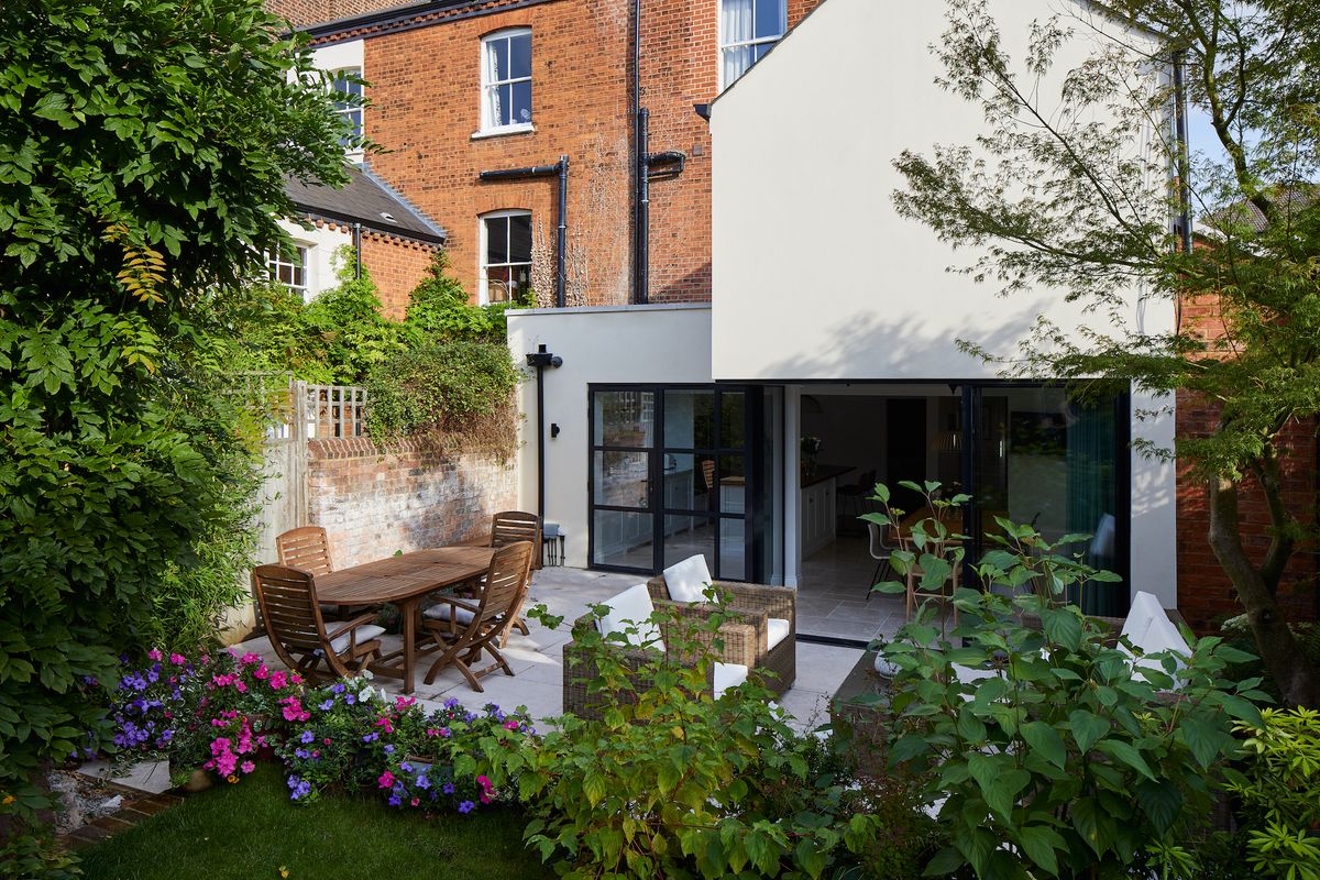 white rendered extension to basement with sunken garden seating area