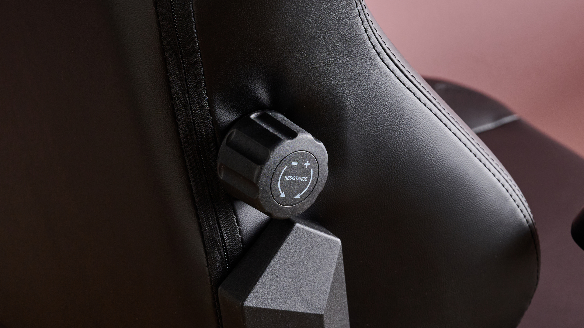 Close-up of lumbar support dial on DXRacer Craft on pink background