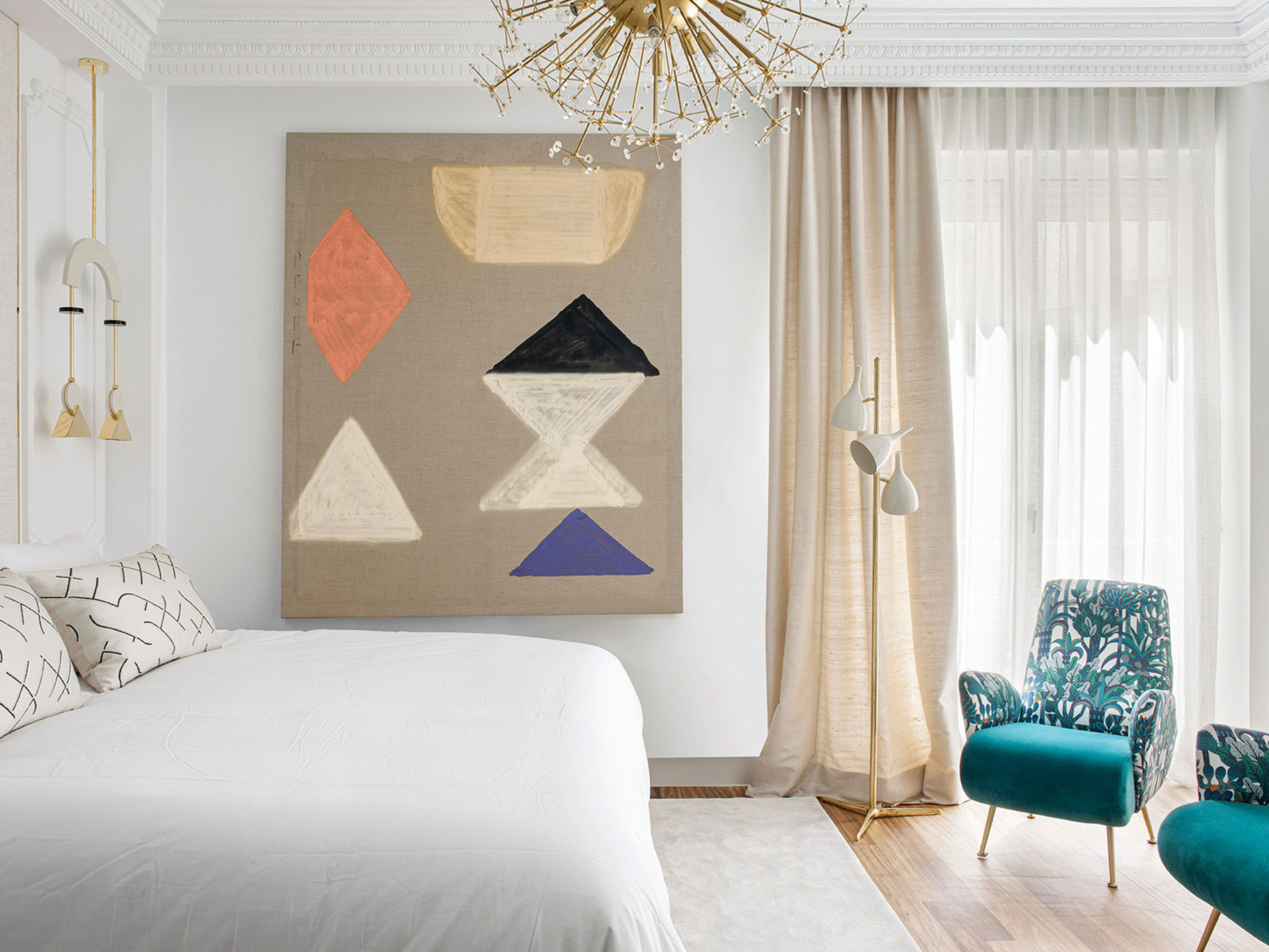 a bedroom with a large piece of art